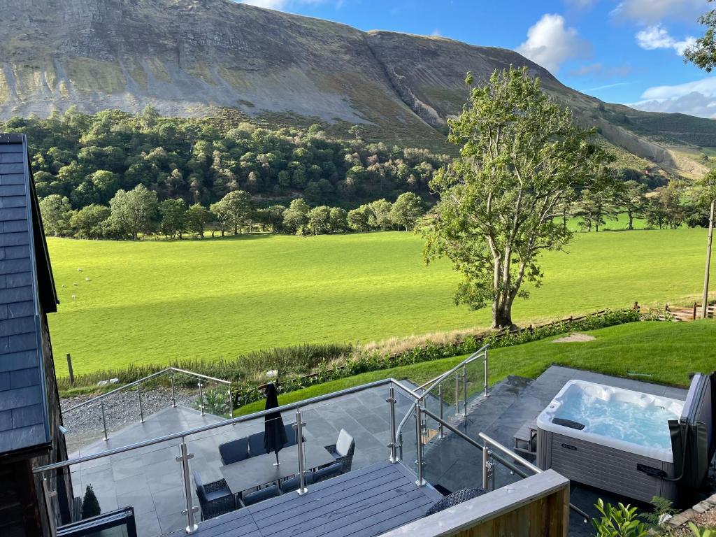 a house with a swimming pool and a mountain at Pennant Uchaf in Llanbrynmair