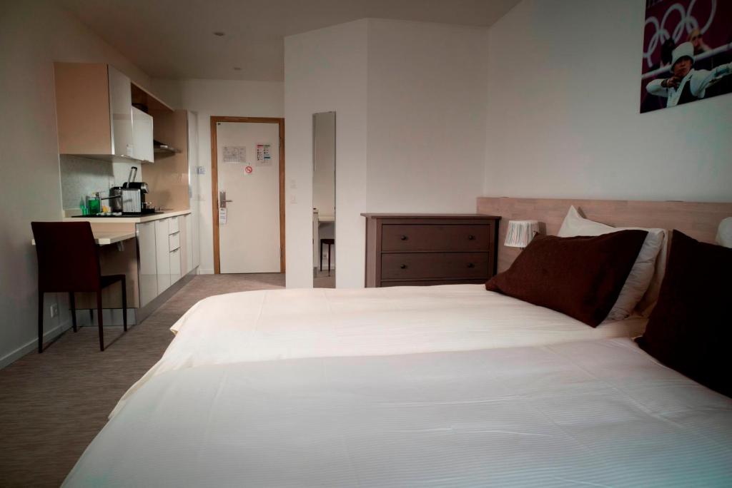 Postel nebo postele na pokoji v ubytování Apart'Hotel 46a