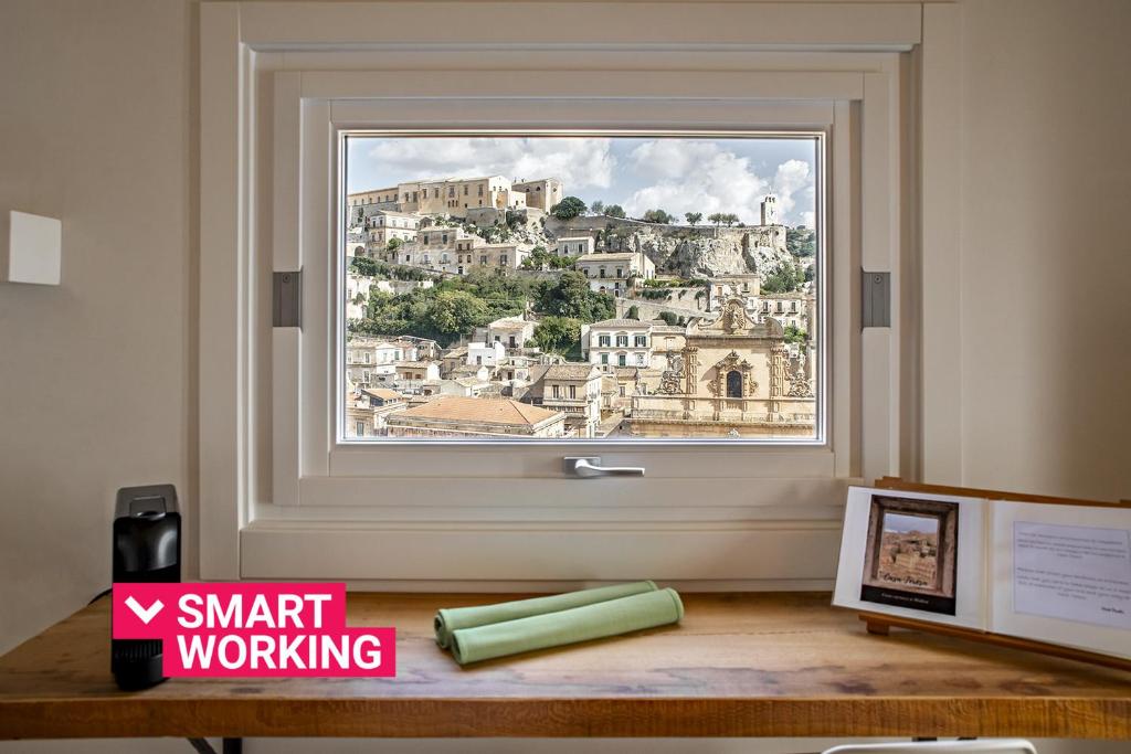 a window with a view of a city at Casa Teresa con vista sul centro storico by Wonderful Italy in Modica