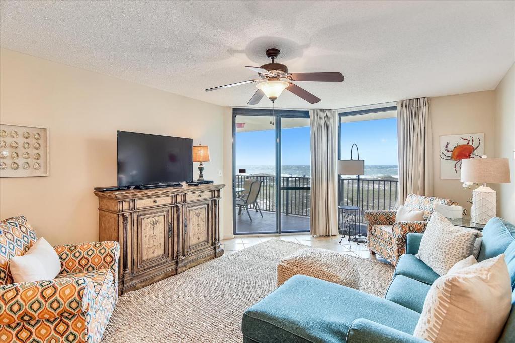 a living room with a flat screen tv and a couch at Phoenix 7 215 in Orange Beach