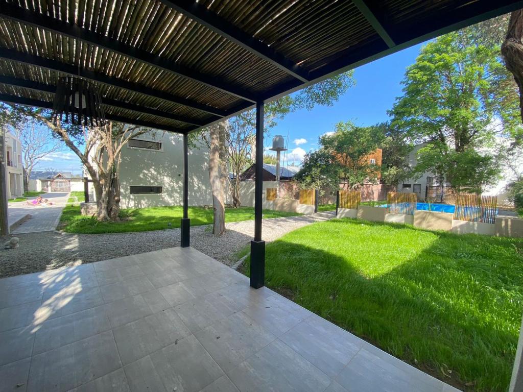 a screened porch with a view of a park at La Escondida Salta 4 in Salta