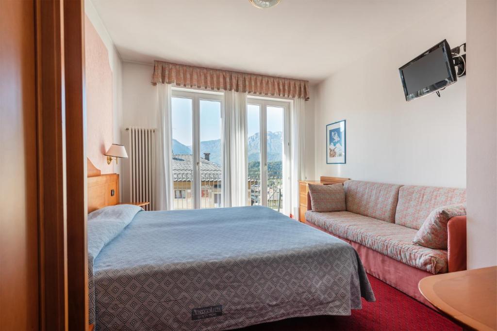 Postel nebo postele na pokoji v ubytování Hotel Lucia