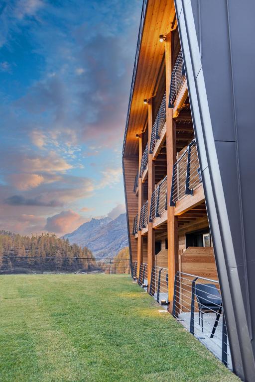 a building with balconies on the side of a field at Cervino - VRetreats in Breuil-Cervinia