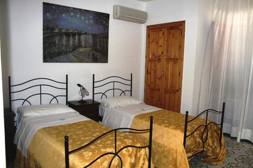 Postel nebo postele na pokoji v ubytování Hotel Tesoriero
