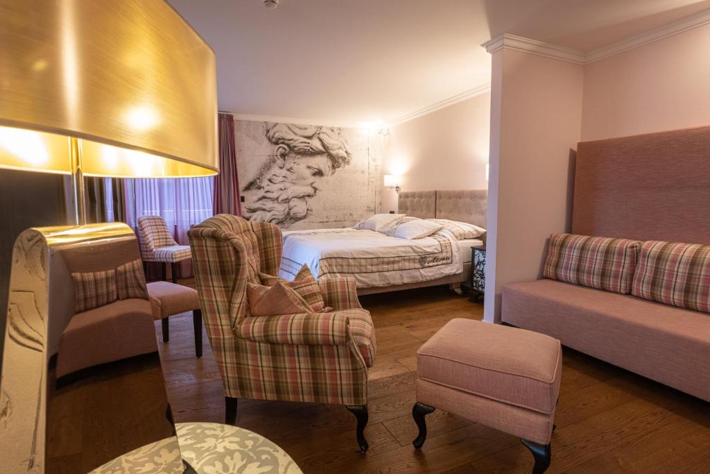 מיטה או מיטות בחדר ב-Home Hotel Arosa