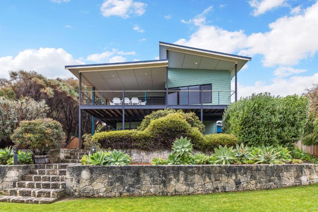 a house on a hill with a retaining wall at Beachside at Margaret River - Spacious Family Beach House in Exclusive Prevelly Location in Prevelly