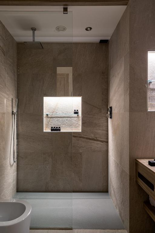 a bathroom with a shower and a tub and a sink at Cervino - VRetreats in Breuil-Cervinia