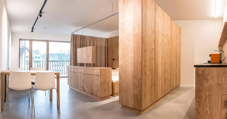 a dining room with a table and chairs in a room at Apartmenthaus Anna in Lustenau