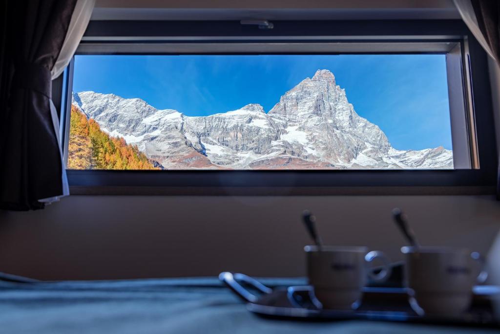 a view of a mountain through a window at Cervino - VRetreats in Breuil-Cervinia
