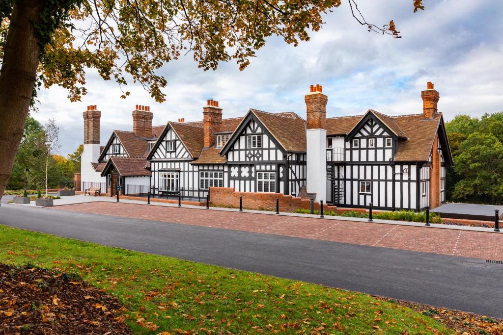 a large black and white building with chimneys at The Springs Resort & Golf Club in Wallingford