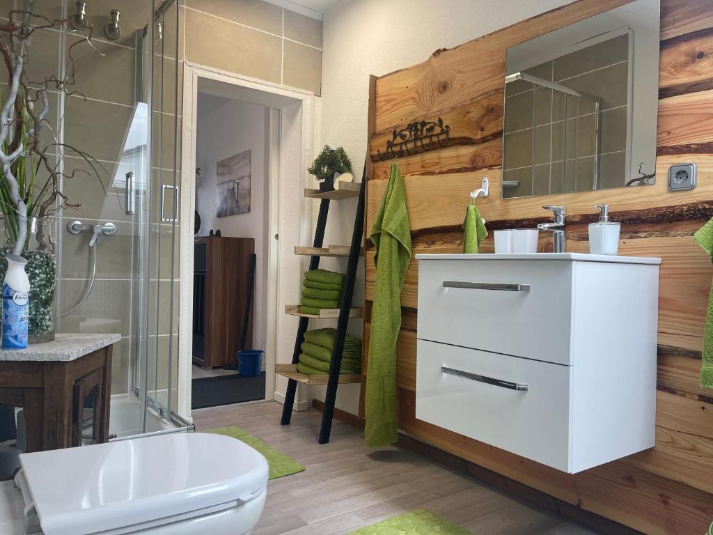 a bathroom with a white sink and a toilet at FeWo by Toni in Salzgitter