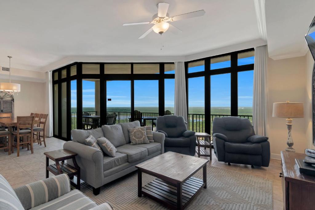 a living room with a couch and chairs and a table at The Oasis at Orange Beach Unit 2114 (formerly Phoenix West II) in Orange Beach