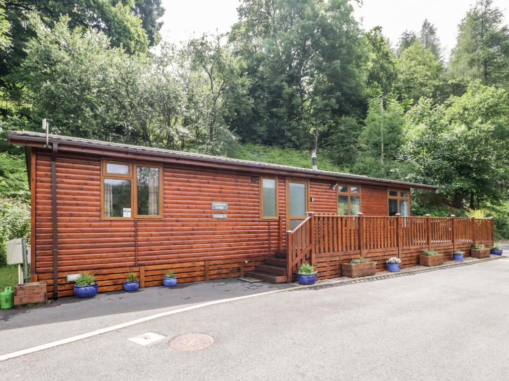 a log cabin with a porch and a deck at Ambleside Lodge in Windermere