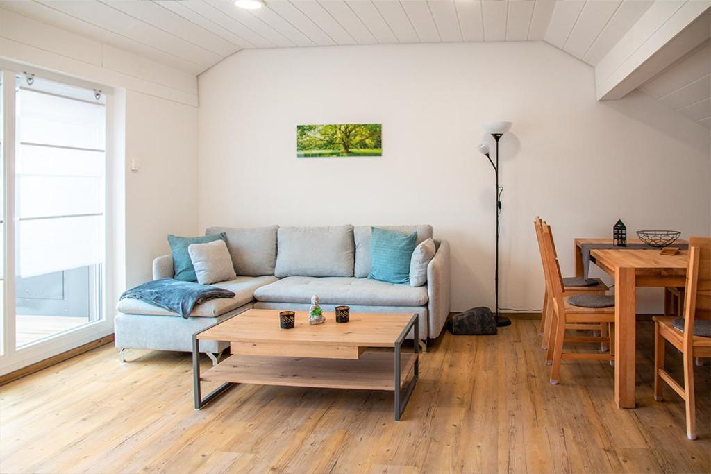 a living room with a couch and a table at Auszeit Bischberg bei Bamberg für Urlauber in Bischberg