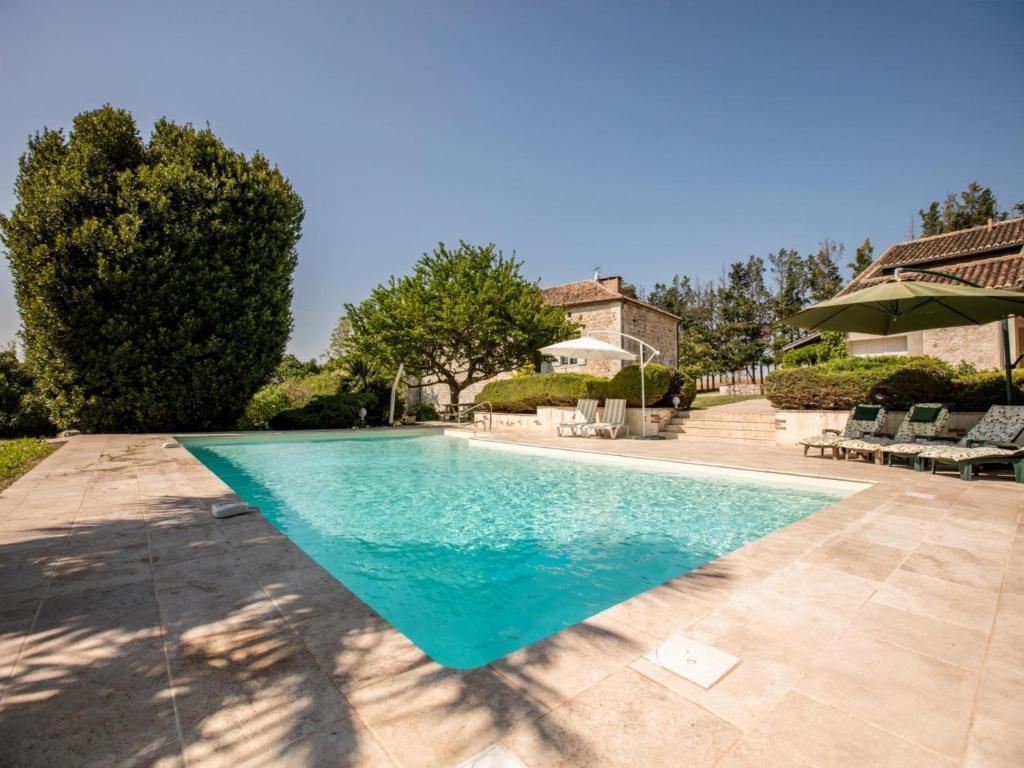 a swimming pool in the backyard of a house at Gite La Séoune in Monjoi