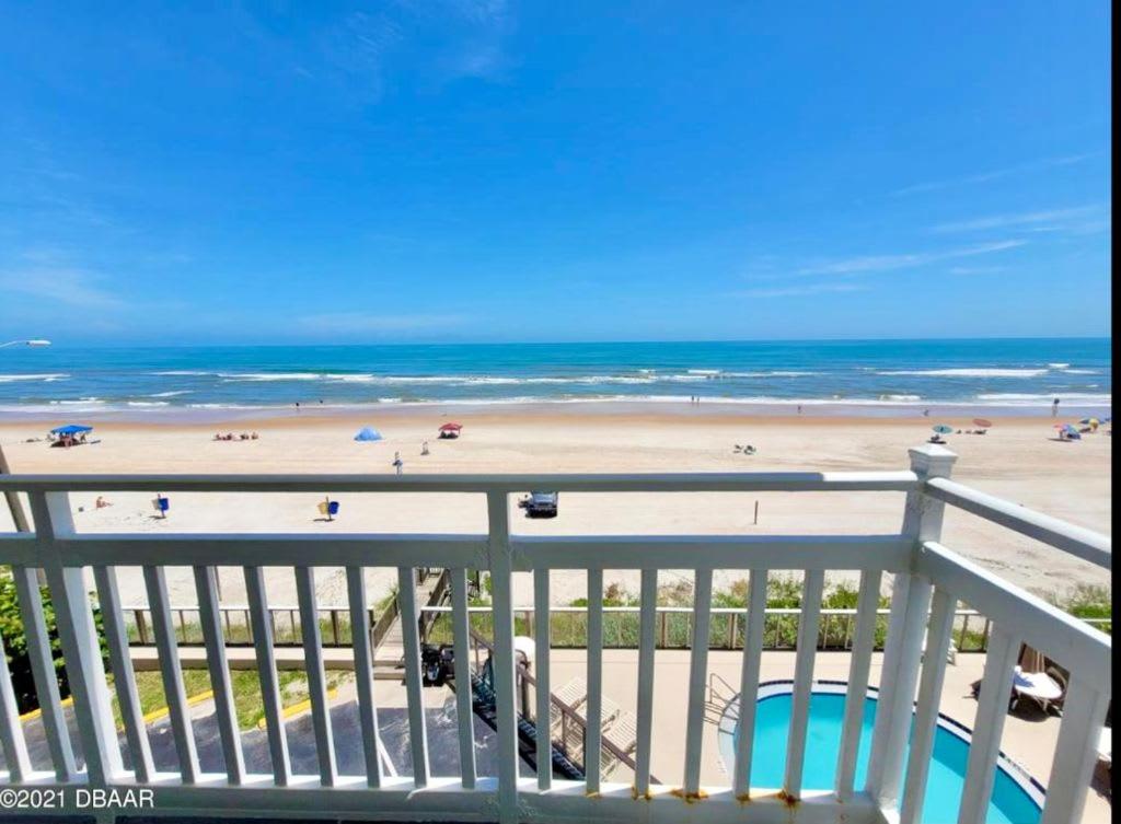a view of the beach from the balcony of a condo at Beachfront Bliss - Suite at Symphony Beach Club in Ormond Beach