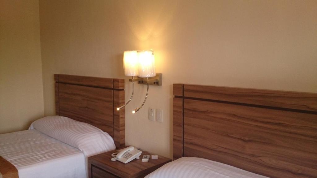 Postel nebo postele na pokoji v ubytování Hotel Oliver Inn - Business Class