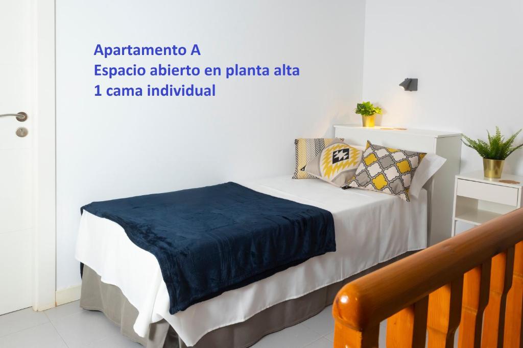 A bed or beds in a room at Sitges Rustic Apartments