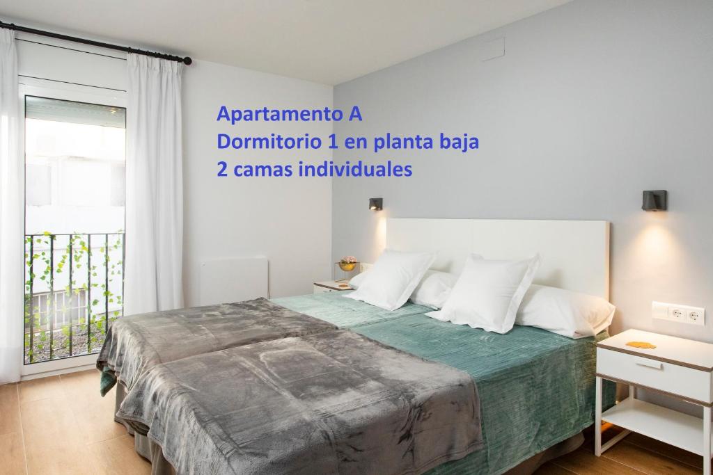 A bed or beds in a room at Sitges Rustic Apartments