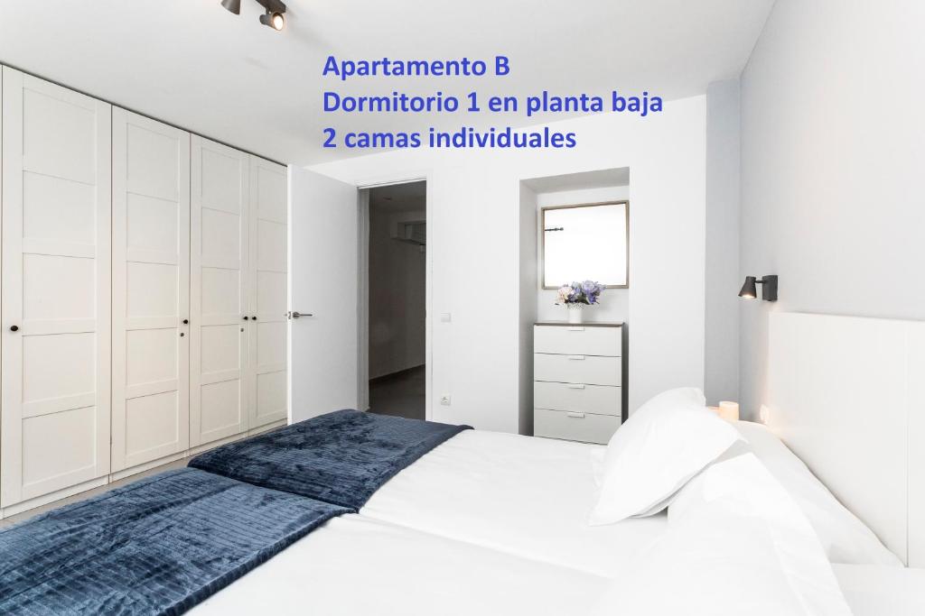 A bed or beds in a room at Sitges Rustic Apartments