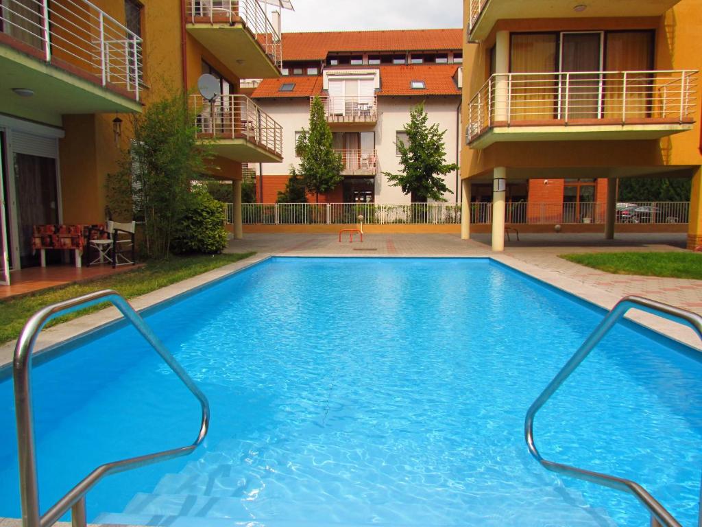 a swimming pool in the middle of a building at Balaton Beach Apartman in Siófok