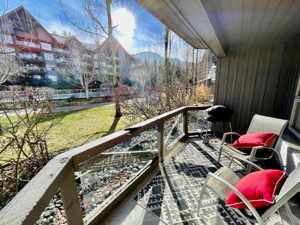 a balcony with chairs and a view of a city at Best ski in ski out condo at Whistler in Whistler