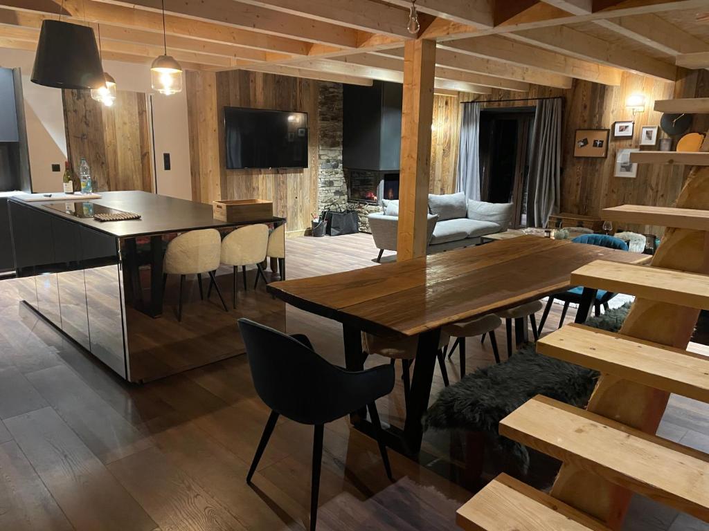 a kitchen and dining room with a table and chairs at Maison de village au coeur d'Allos in Allos
