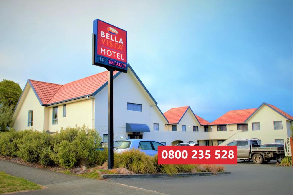 a real estate sign in front of a motel at Bella Vista Motel Taupo in Taupo