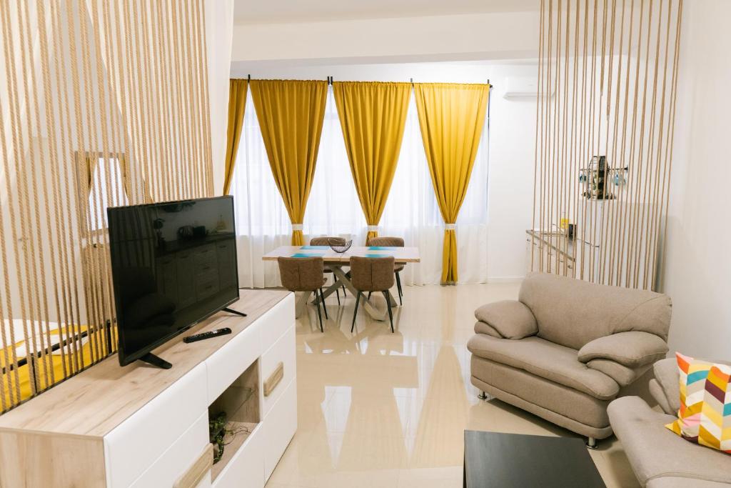 a living room with a television and a couch at Chic Studio in Bucharest