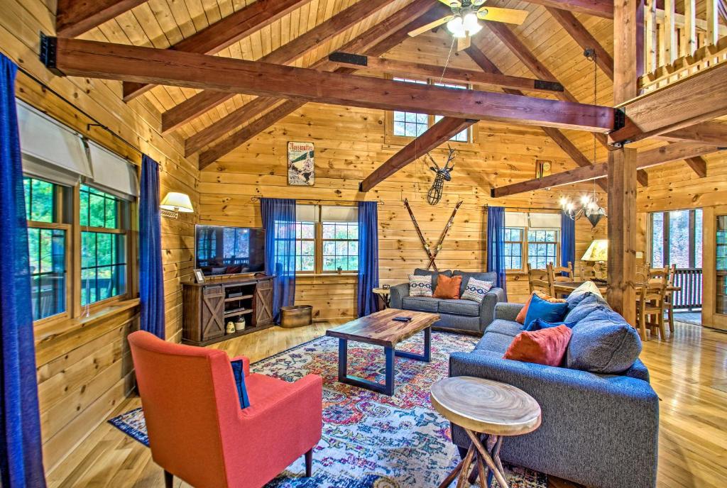 a living room with a couch and chairs in a cabin at Massanutten Resort Log Cabin with Mountain Views! in McGaheysville