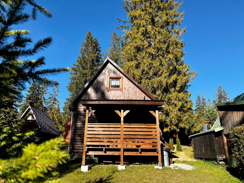 a small wooden cabin with a small window on it at Chatka vo Vysokých Tatrách in Tatranska Strba
