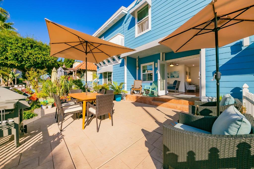 a patio with a table and chairs and umbrellas at Mission Beach Getaway Condo in San Diego