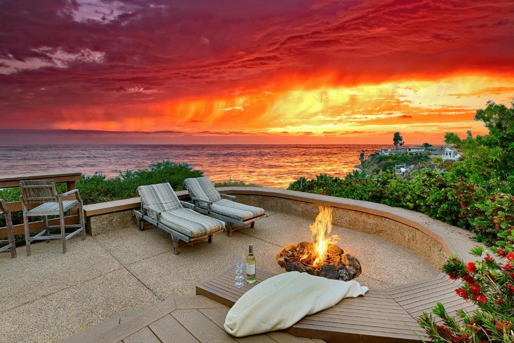 a fire pit on the beach with a sunset at Forever Views in San Diego