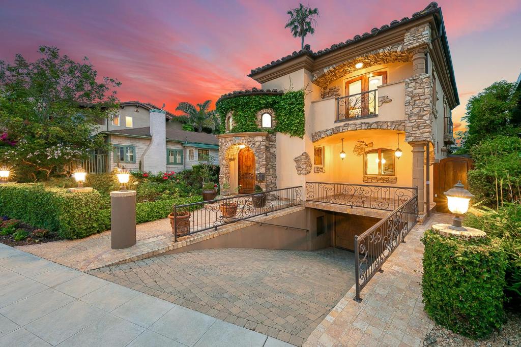 a large house with a balcony in a yard at Tuscan Village Villa in San Diego