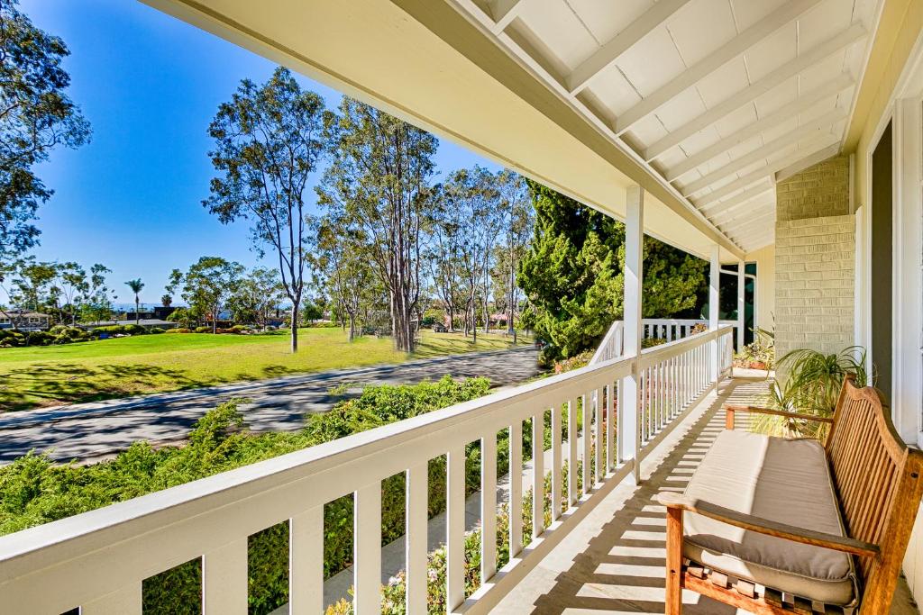 a porch with a bench and a view of a park at DP-343 - Dana Point Parkside Cottage in Capistrano Beach
