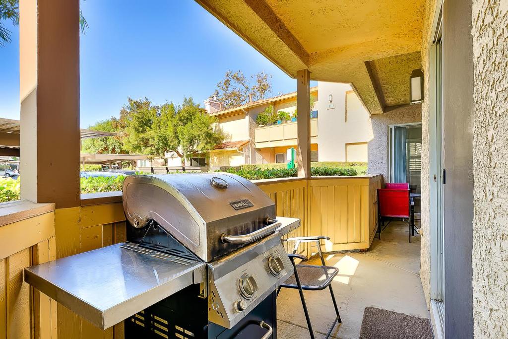 an outdoor kitchen with a grill on a patio at Ritz Point Condo in Dana Point