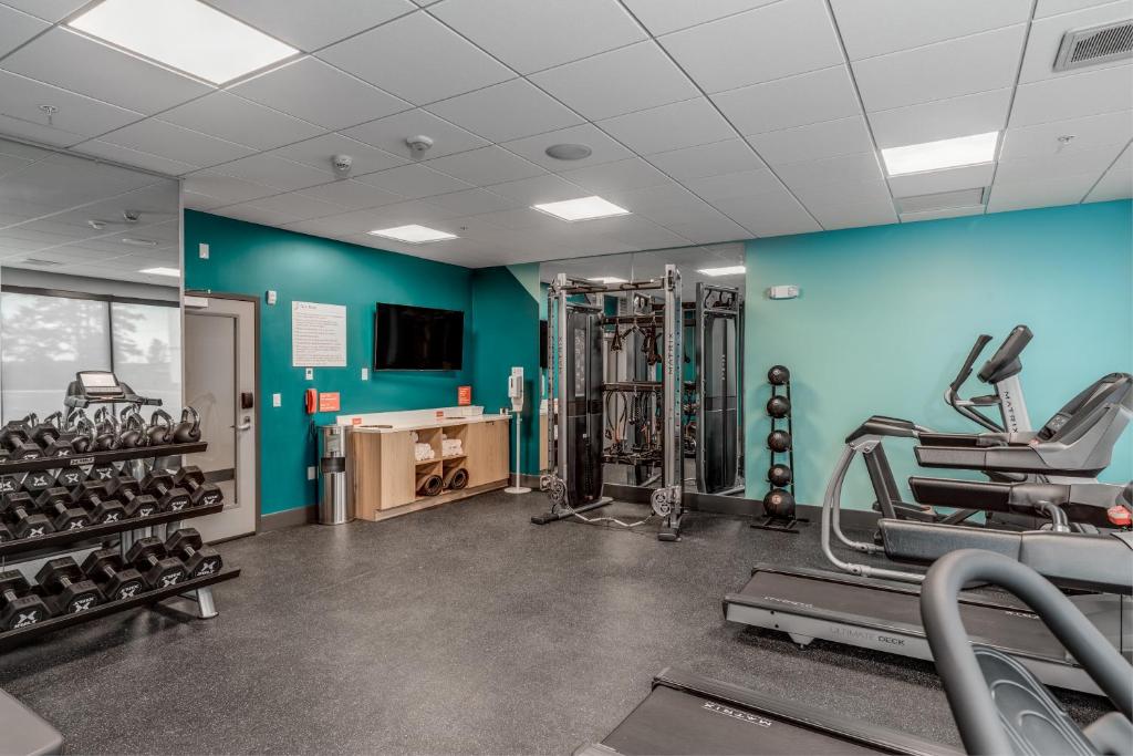 a gym with treadmills and machines in a room at avid hotels - Zeeland by IHG in Holland