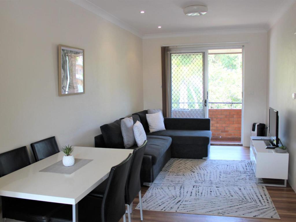 a living room with a couch and a table at Sand Sea 5 in Sawtell