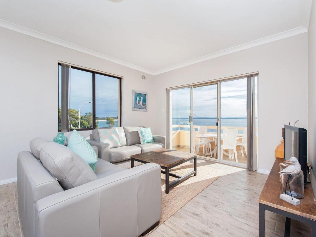 a living room with a couch and a table at Bay Village Unit 6 47 Shoal Bay Road in Shoal Bay