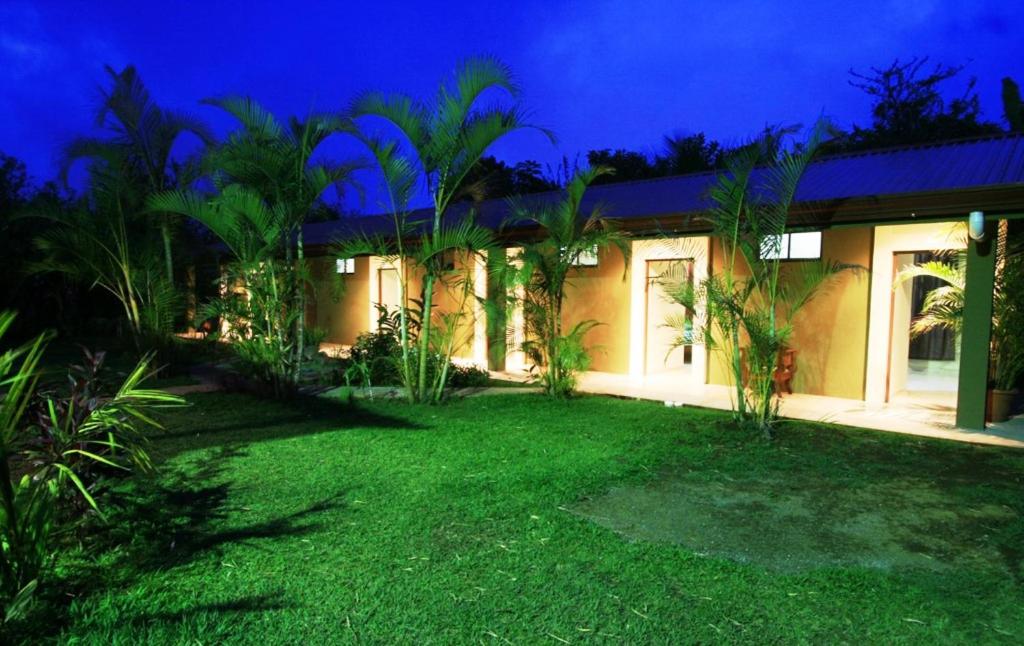 a house with a lawn in front of it at night at B&B Garden Grecia in Grecia