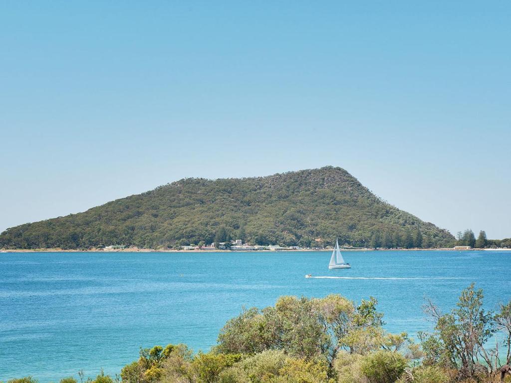 a sailboat in the water with a small island at Luskin Lodge Unit 15 29 Weatherly Close in Nelson Bay