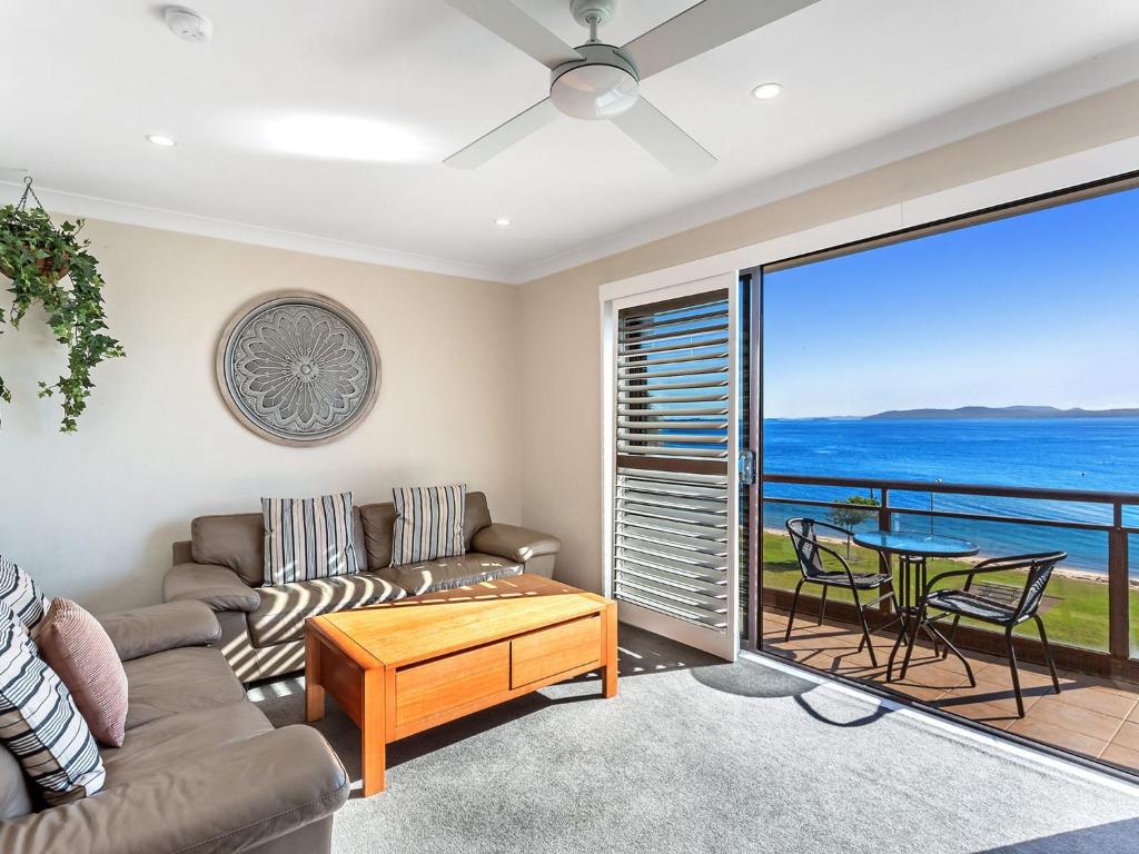 a living room with a couch and a table at Collendina Unit 6 19 Kurrawa Close in Nelson Bay