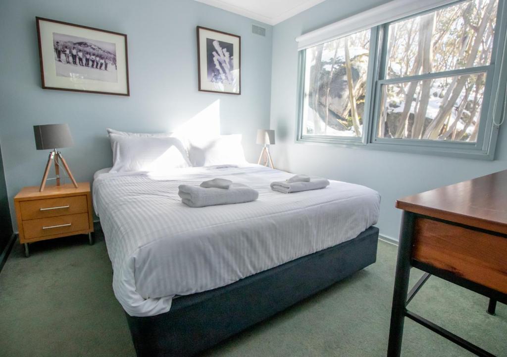 En eller flere senge i et værelse på Altitude Apartment 1