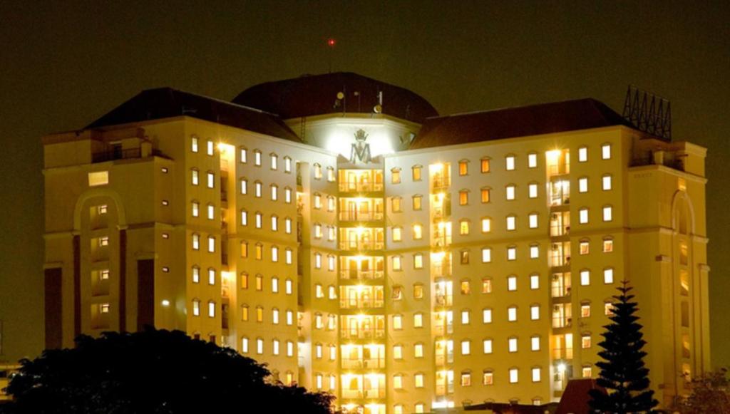 a large building with lights on at night at youre at - The Majesty Apartment in Bandung