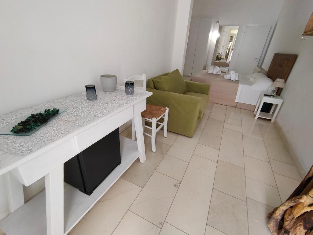 a kitchen and living room with a table and a couch at Sal.to nel blu in Leverano
