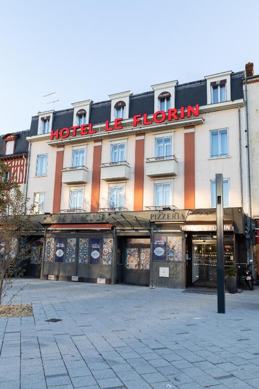 a hotel building with a sign on the front of it at Hôtel Le Florin in Rennes