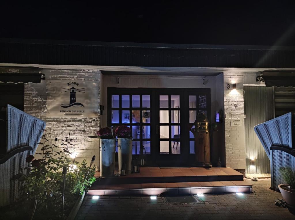 a front door of a house at night at Pension zur Perle in Büsum