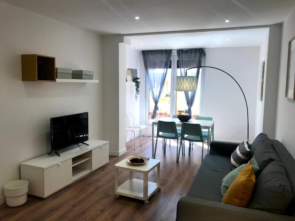 INSIDEHOME Apartments - La Casita de Oscar في بالينثيا: غرفة معيشة مع أريكة وطاولة