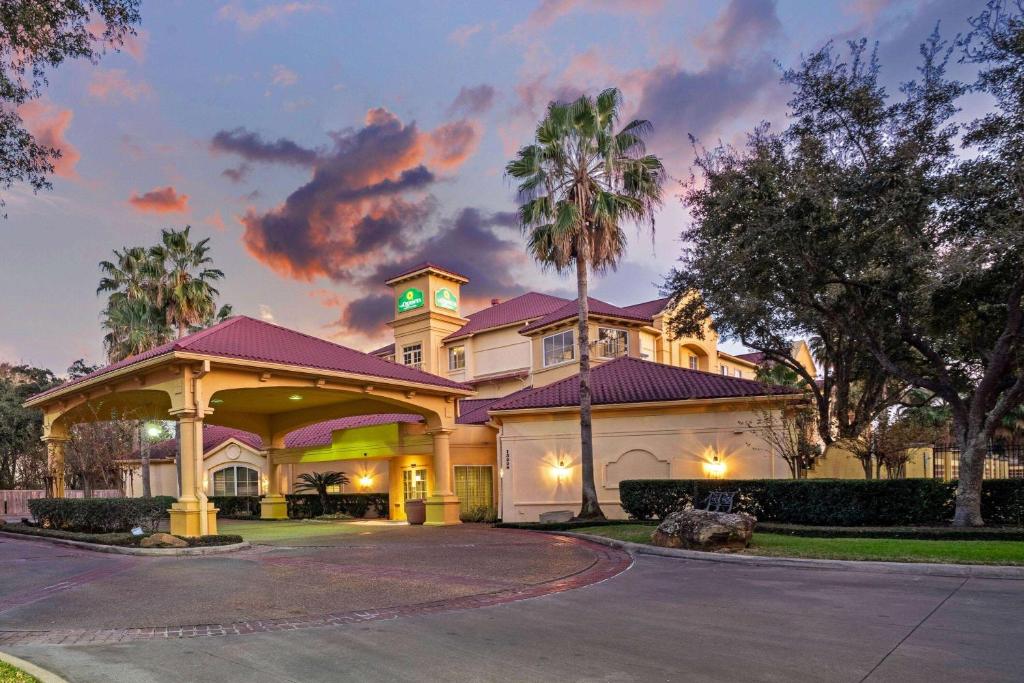 a large house with a driveway in front of it at La Quinta by Wyndham Houston West Park 10 in Houston