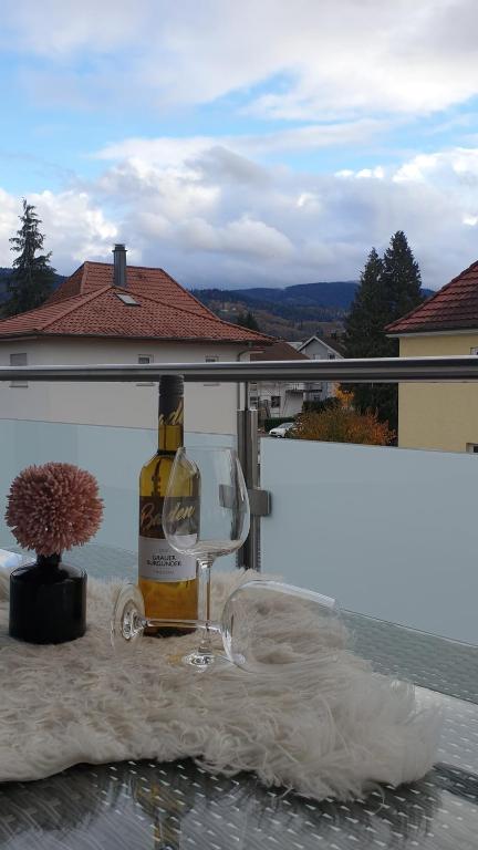 a bottle of wine and a glass on a table at Boardingappartement Windeckblick, ruhige, zentrale Lage mit großem Südbalkon in Bühl